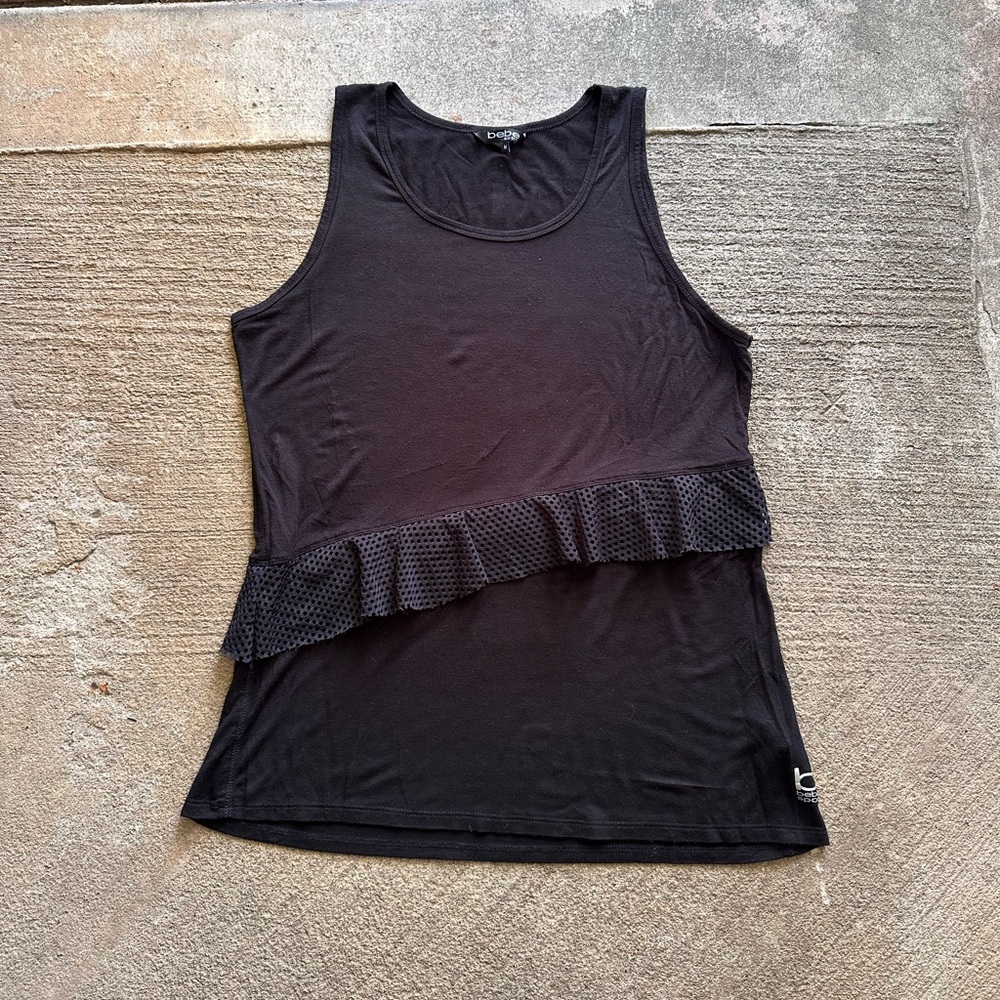 Bebe sports black sleeveless shirt with fishnet ruffles